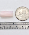 Premium Pink Calcite Faceted Tube Beads 20x10mm Genuine Natural Stone For Jewelry Making next to a quarter for size comparison.