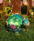Garden Turtle Statue Outdoor Decor Resin Figurine With Glass Solar Lights glowing on grass at night