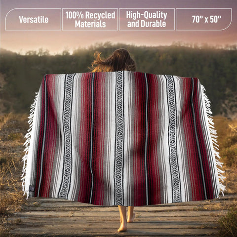 Authentic Handmade Falsa Baja Blanket Soft And Lightweight Mexican Throw Cherry 70x50 on woman's back on path