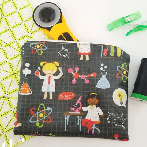 Science-themed fabric pouch next to quilting tools; features Liquid Vinyl Gel Coating For Fabrics Waterproof And Stain Resistant 8.68 Oz.