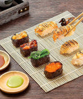 Sushi displayed on bamboo mat from 28 In 1 Sushi Making Kit With Roller And Bamboo Mats Bazooka Nigiri Gunkan Molds Musubi Maker Rice Ball Mold And More Easy Home Sushi Set For Beginners Ready To Roll Like A Pro.
