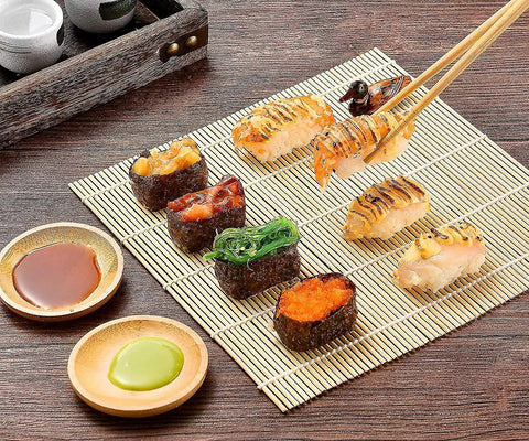 Sushi displayed on bamboo mat from 28 In 1 Sushi Making Kit With Roller And Bamboo Mats Bazooka Nigiri Gunkan Molds Musubi Maker Rice Ball Mold And More Easy Home Sushi Set For Beginners Ready To Roll Like A Pro.