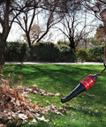 Man using High Performance Blower Attachment With Concentrator For Attachment Capable Trimmers Polesaws to clear leaves