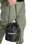 Person carrying compact Smokeless Tabletop Fire Pit For Patio And Camping in black carry bag, showcasing portability.