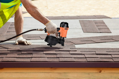 Person using CN45C 3/4-Inch To 1-3/4-Inch Coil Roofing Nailer with 15-Degree Drive and 120-Nail Magazine on roof