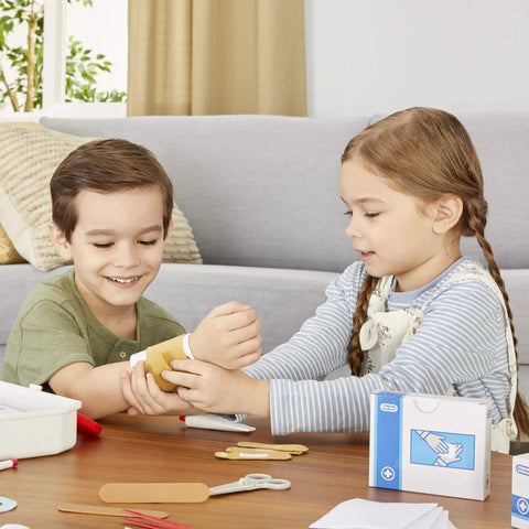 Children playing with a Realistic Kids First Aid Kit For Pretend Doctor Play With 25 Accessories Including Gauze Pads And Bandages.