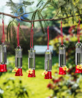 Set Of 6 Mini Hummingbird Feeders With Hanging Wires, Transparent Outdoor Hummingbird Feeder Set With Flower Shaped Sipping Outlet, Includes 3 Cleaning Brushes For Easy Cleaning On Patio, Lawn, Garden And Backyard hanging from a tree branch.