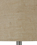 Close-up of burlap drum shade on Blue Embossed Glass Table Lamp With Jute Wrapped Base And Tall Silver Finial, natural texture detail.