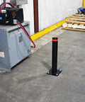 Badass 24 Inch Steel Garage Safety Bollard Wall Defender Pipe Guard With Pre Drilled Mounting Holes Matte Black Finish on concrete floor.