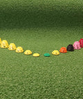 Pro Speed Indoor Golf Tees Eight Pack With Enhanced Durability, Flexible Plastic, Varied Heights arranged on green turf