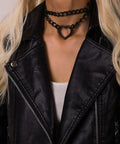 Dope Gothic Punk Leather Choker Necklace Featuring Adjustable Black Heart Chain for edgy grunge style worn with a leather jacket.