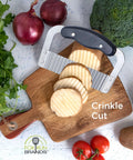 Front view of stainless steel crinkle cutter with black handle on wooden cutting board; Fox Run Brands logo visible