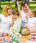 Family picnic featuring filled Heavy Duty Square Aluminum Foil Cake Pans 50 Pack Hot Pink 10oz with secure lids.