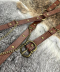 Close-up of Snag This Fresh Medieval Faux Leather Wrap Belt To Kick Up Your Vintage Look With Adjustable Chain Details and a buckle.