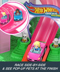 RacerVerse Barbie Spiral Track Set With Barbie Malibu And Barbie Brooklyn Cars on pink track, pop-up pets at finish line.
