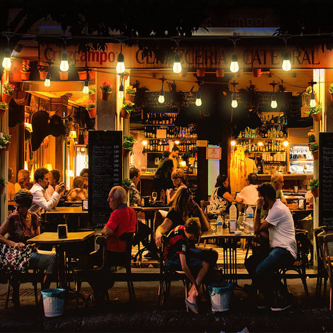 Outdoor cafe illuminated by Weatherproof Outdoor Cafe String Lights 48 Ft Per Strand Linkable End To End Up To 1920 Ft With Edison Bulbs.