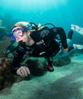 Diver underwater using MK11 EVO C370 Dive Regulator System For INT With Air Balanced Diaphragm, exploring coral reef.