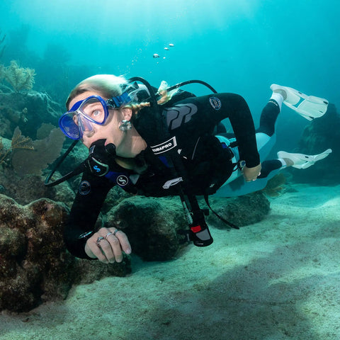 Diver underwater using MK11 EVO C370 Dive Regulator System For INT With Air Balanced Diaphragm, exploring coral reef.