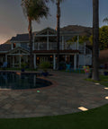 Backyard with lit 6x9 Inch Paver Light Warm White 2700K Drive Over Rated 12V Waterproof Landscape Lighting by poolside.