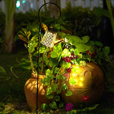Watering Can Solar Lights With Cascading Glow For Outdoor Vibe Hanging Lantern illuminating garden plants at night