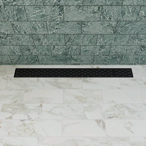 32 Inch Linear Shower Drain With Slick Black Matte Trim Guides Flow Fast Using Boss Level 14 Gauge 304 Stainless Steel on tiled floor.