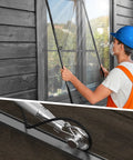 Worker using Heavy Duty Screen Roller Tool Kit For Window And Door Screens Stainless Steel Construction 3 Wheel Types For Spline Replacement