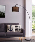 Tall 71 inch arc floor lamp with black fabric shade and steel base, modern standing light for living room over couch.
