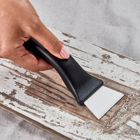 Ceramic Utility And Barbecue Scraper For Home And Kitchen Surfaces in use on wood, durable ceramic blade visible, ergonomic handle