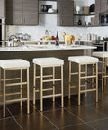 Backless Bar Stool With Gold Frame And White Vinyl Cushioned Seat 30 Inch Counter Height in modern kitchen setting