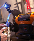 Eight Inch Bench Grinder Powered By A Beefy Four Point Eight Amp Motor Hitting 3450 RPM, features adjustable eye guards and LED work lights.