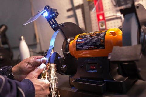 Eight Inch Bench Grinder Powered By A Beefy Four Point Eight Amp Motor Hitting 3450 RPM, features adjustable eye guards and LED work lights.