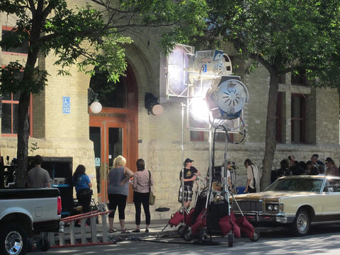 Film crew setting up heavy duty cotton sash cord size 8 1 quarter inch by 1200 feet spool for theater rigging outside building