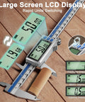 12 Inch Digital Caliper With Rechargeable Stainless Steel Body, Type C Charging, Auto On Off, Quick 50 Minute Charge For Months Of Everyday Use, Ideal For Woodworking, Metalworking, And DIY Projects, Precise Measurements Every Time. Digital caliper on wood surface with LCD display and inch/metric readouts.