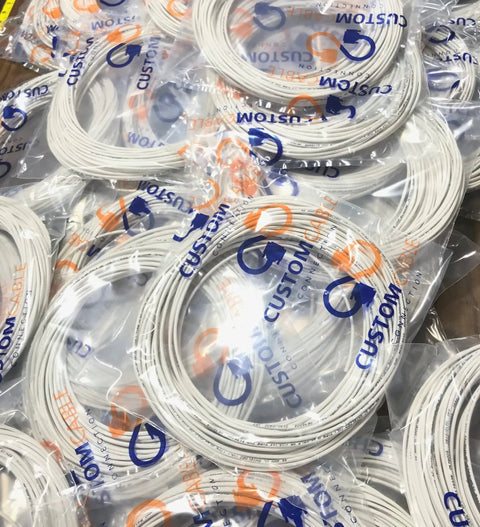 Bundles of 22 AWG 4 Conductor Shielded Copper Wire For Low Voltage Installations, UL Listed 300V, wrapped in plastic packaging.