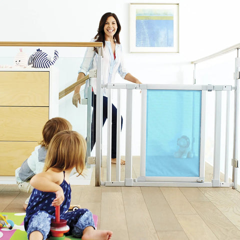 Vibe Mesh And Steel Baby Gate In Berry With Turnkey Mounts, visible between open staircase, children playing nearby