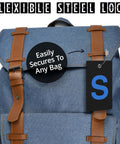 Initial Luggage Tag With Fully Bendable Design And Stainless Steel Loop attached to a blue backpack showing ease of securing to bags.