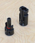 Heavy Duty Solar Bulkhead Connector Pair MC4 30A 1000V IP67 Black Waterproof connectors on wooden background