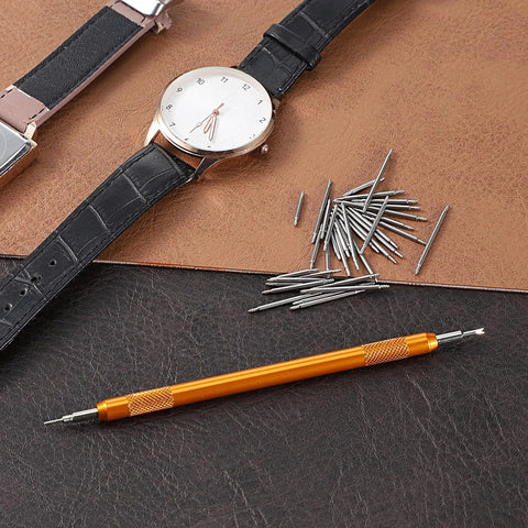 Heavy Duty Watch Band Pins And Spring Bar Tool Kit With 76 Stainless Steel Pins shown with watch and tool on leather surface.
