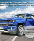 One Inch Front Leveling Lift Kit And Heavy Duty Strut Spacers To Drop The Sag And Raise The Bar For Chevy Silverado 1500 And Gmc Sierra 1500 Pickup Trucks 2007 Through 2019 blue truck showing increased tire clearance on the road.