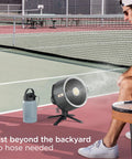 FlexBreeze Pro Mist Fan Indoor Outdoor Chill Machine with Built-In Misting on a tennis court, charcoal grey model.