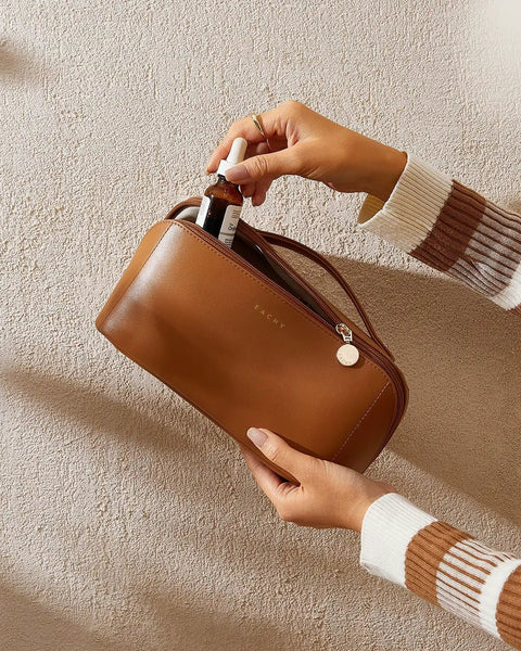 Travel Makeup Bag For Women With Large Capacity, Waterproof Cosmetic Pouch being opened by a person, brown, medium size