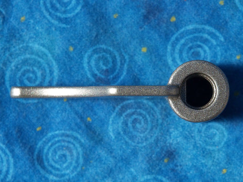 Top view of metal paddle from 8-BBP-P070 Paddle Blade Replacement Pack of 2 for BB-PAC20 Bread Machine on blue surface.