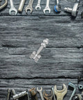 Heavy Duty Stainless Steel V Groove Sliding Door Pulley Wheel Featuring Dual Ball Bearings on a workbench surrounded by tools.