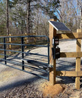 Automatic gate opener with AXLC Security Kit Locking Clevis Pin For Automatic Gate Opener Systems installed on wooden post.