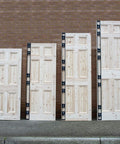 Four wooden doors with hinges, illustrating the All-In-One Adjustable Door Hinge Jig Installation Kit For 2 Ft 6 In To 9 Ft Doors.