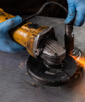 Heavy Duty Textured Nitrile Disposable Gloves Blue Medium 3.5 Mil Rugged Grip Workhorse Exam Gloves in use while operating a grinder.