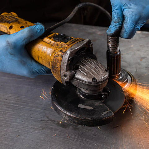 Heavy Duty Textured Nitrile Disposable Gloves Blue Medium 3.5 Mil Rugged Grip Workhorse Exam Gloves in use while operating a grinder.