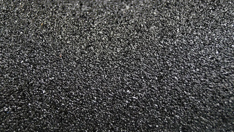 Close-up of Kickass Anti Skid Safety Tape For Outdoor And Indoor Floors black grip surface with aluminum oxide texture.