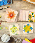 Six Shapes 1 Inch Paper Punches for crafting scrapbooking and card making on wooden table with colorful craft supplies