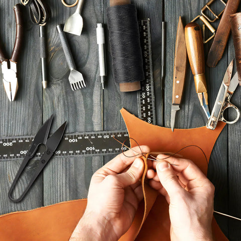 Hands working with Waxed Leather Sewing Thread Kit With 55 Yard Spools And Pro Grade Needles for upholstery repair.